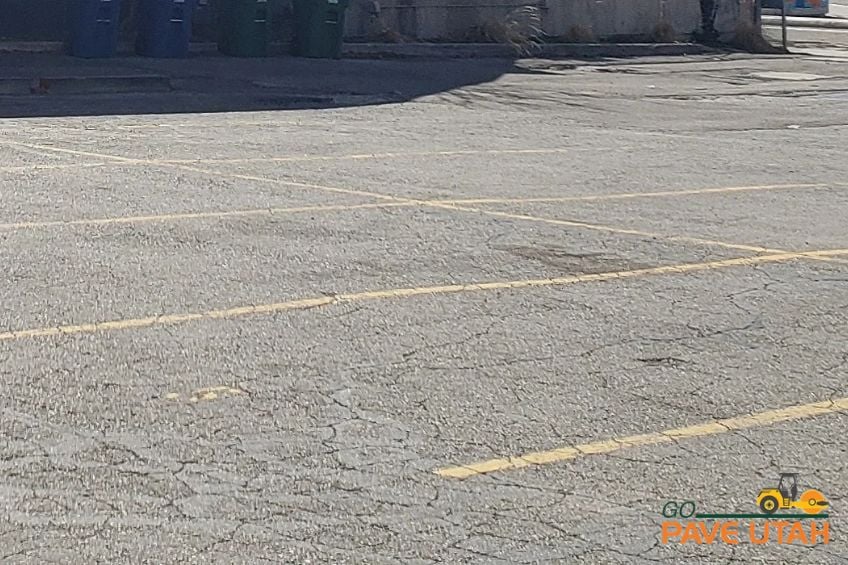 You may think of your commercial parking lot as one large asphalt surface, but vehicles rarely use every square foot equally. Customers favor certain entrances. Delivery trucks follow familiar routes. Garbage trucks repeatedly approach the same enclosure. Employees may cut across the same sections day after day. Over time, your property develops a traffic pattern that probably never appeared on the original parking lot plan. For Utah property managers, recognizing those patterns can change the way you approach asphalt maintenance. Instead of looking at the parking lot as one uniform surface, it can be more useful to identify where traffic repeatedly places the greatest demands on the pavement. Your Busiest Asphalt May Not Be Where Cars Park Parking stalls certainly receive traffic, but some of the hardest-working asphalt is found between them. Main entrances, drive aisles, intersections within the lot, loading areas, dumpster approaches, and connections to public streets can experience repeated vehicle movement throughout the day. Take a look at how vehicles actually travel through your property rather than how they were intended to travel. A shortcut across the lot or a heavily favored entrance can concentrate traffic in areas that may receive considerably more use than surrounding pavement. Those real-world patterns provide useful information when evaluating pavement conditions. Turning and Stopping Change the Way Pavement Is Used A vehicle traveling straight through a parking lot interacts with the pavement differently from one that is repeatedly braking, turning, accelerating, or maneuvering into position. That makes areas near entrances, intersections, loading zones, and tight turns worth watching closely. Heavy commercial vehicles can make these locations even more demanding. Delivery trucks, waste collection vehicles, maintenance equipment, and other large vehicles may travel the same route every visit. If pavement distress begins appearing in one of these concentrated traffic areas, the location itself provides context. The problem may not be random when the same piece of asphalt is handling repeated vehicle movements every day. Your Property's Operations Can Change Before the Parking Lot Does Commercial properties evolve. A new tenant can increase deliveries. A restaurant can generate different traffic than the previous business. A loading area may become busier. A dumpster may be relocated. Customer traffic may begin favoring a different entrance. The pavement, however, does not automatically change when property operations do. Asphalt that once handled occasional traffic may eventually become part of a primary route. That is why understanding how a property is currently being used matters. The traffic assumptions made years ago may no longer reflect what the parking lot experiences today. Wear Patterns Can Help Focus an Inspection A pavement inspection should include more than a general walk around the property. Pay particular attention to places where vehicles repeatedly turn, stop, load, or travel. Cracking, depressions, rutting, potholes, surface deterioration, or recurring damage in these locations may deserve further evaluation. This does not mean every busy area automatically needs asphalt repair. It means traffic patterns can help identify where closer attention may be worthwhile. Comparing heavily traveled sections with quieter areas can also provide a clearer picture of how different parts of the parking lot are performing. Manage the Parking Lot You Actually Have Your striping may tell drivers where to go, but everyday use ultimately determines where much of the pavement wear occurs. Understanding that difference can make asphalt maintenance more specific to the property instead of treating every section of pavement exactly the same. Go Pave Utah works with Utah property managers and commercial property owners to evaluate asphalt conditions and determine where maintenance or repair may be appropriate. By paying attention to how vehicles actually move through the property, you can better understand which areas are doing the most work and which ones deserve the closest attention.